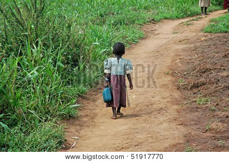 Ugandan Girl Carries Jerry Can On A Dirt Path