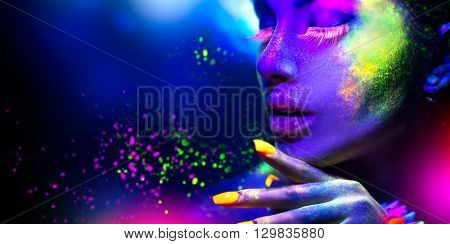 Fashion model woman in neon light, portrait of beautiful model with fluorescent make-up, Art design of female disco dancers posing in UV, colorful make up. Isolated on black background