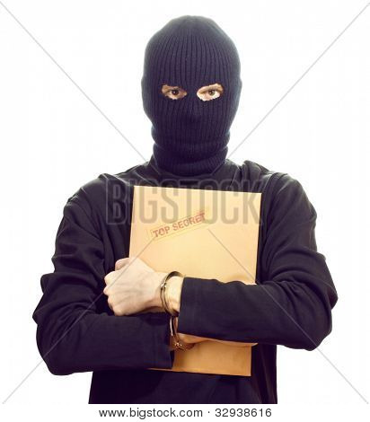 Bandit in black mask in handcuffs with top secret envelope isolated on white