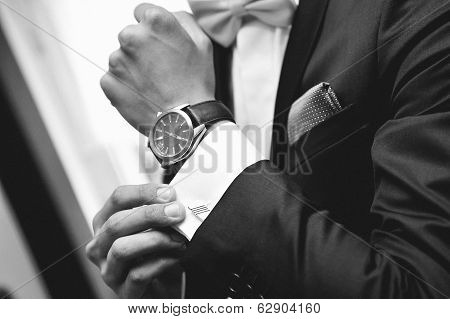 Man with suit and watch on hand