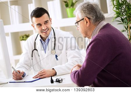 Doctor Explaining Prescription To Senior Patient