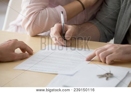 Couple Renters Tenants Signing Rental Agreement Renting New House, Customers Buyers Put Signature On