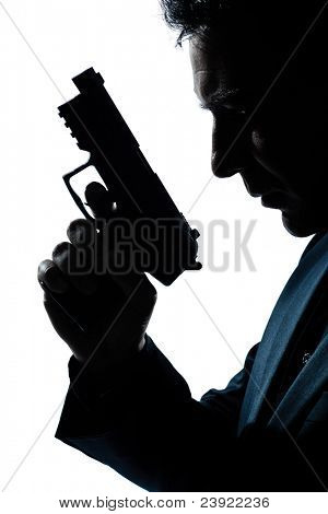 one caucasian spy criminal policeman detective man holding gun portrait silhouette in studio isolated white background