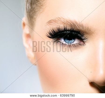 Beauty makeup for blue eyes. Part of beautiful face closeup. Perfect skin, long eyelashes. Make up concept. 