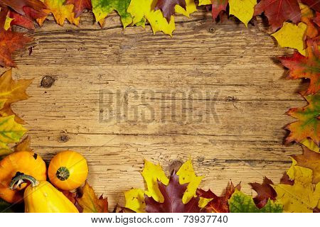 Thanksgiving Autumn Fall background with red, brown and yellow leaves and pumpkin