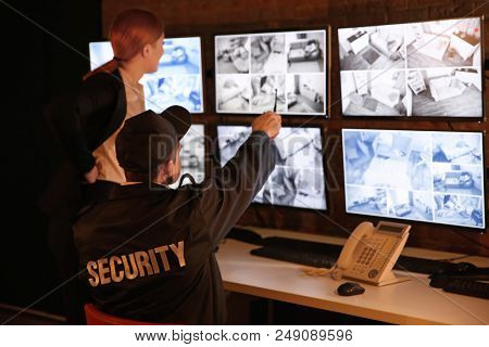 Security guards working in surveillance room