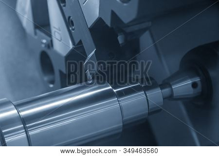 The Cnc Lathe Machine In Metal Working Process Cutting The Metal Shaft Parts With In The Light Blue 