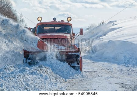 truck cleaning road in winter