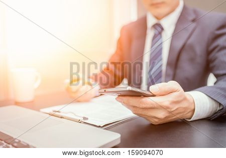 Businessman hand using mobile phone on sunset. Business looking smartphone. Business playing smartphone. Business using smartphone. Uniform business. Business room. Business using mobile. Business using internet.