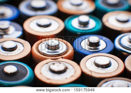 Close up top view on rows of selection of AA batteries energy abstract background of colorful batteries. Alkaline battery aa size. Several batteries are next to each other. Many aa batteries.