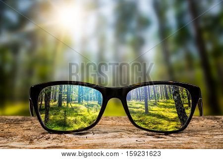 glasses focus background wooden eye vision lens eyeglasses nature reflection look looking through see clear sight concept transparent sunrise prescription sunset vintage sunny sun retro - stock image