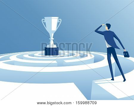 businessman has climbed to the top of the maze and trying to find the way to the cup worker looks how to get through the maze and get a prize. business concept the way to victory