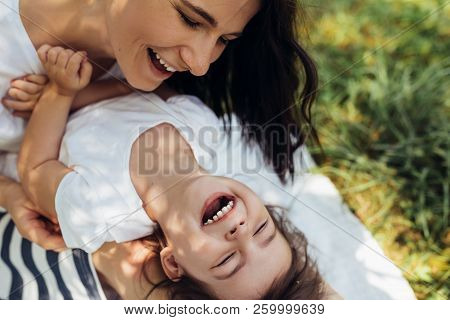 Cropped Beautiful Happy Mother And Her Little Smiling Daughter Outdoors. Cute Mom And Her Child Play