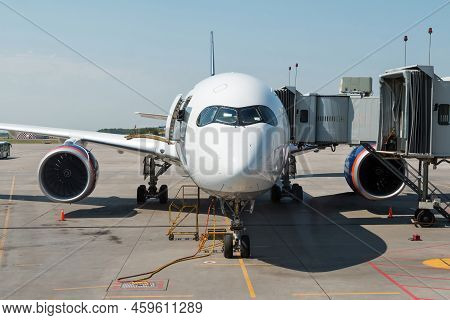 Front View Of The White Wide Body Passenger Jetliner At The Airgate