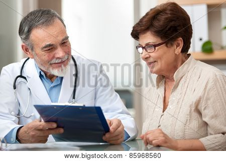 doctor talking to his female patient at office