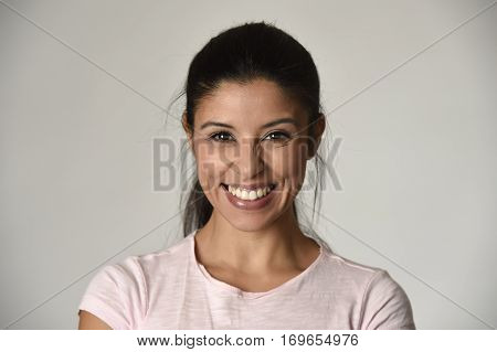 portrait of young beautiful and happy Latin woman with big toothy smile excited and cheerful in charming face expression isolated clear grey background in female happiness emotion