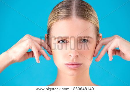 Health, Spa And Beauty Concept - Clean Face Of Beautiful Young Woman Pointing To Her Ear