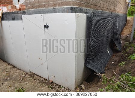 Foundation Wall Insulation, Damp Proofing On The House Corner.  House Basement, Foundation Insulatio