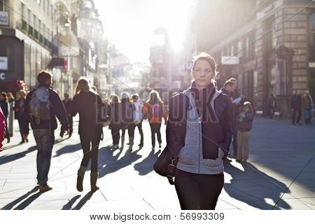 Urban Girl Striding Through City Area