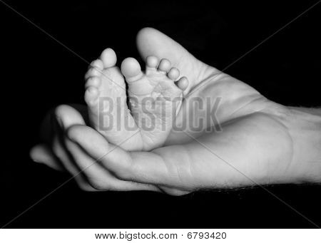 Baby feet in Daddy's hand