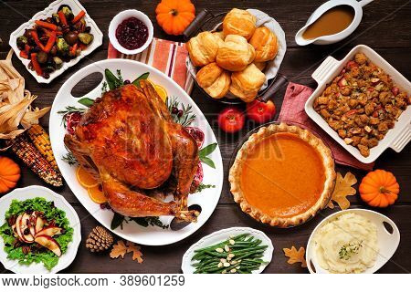 Classic Thanksgiving Turkey Dinner. Above View Table Scene On A Dark Wood Background. Turkey, Mashed