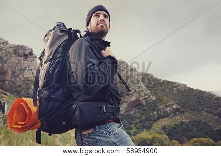 Adventure man hiking wilderness mountain with backpack, outdoor lifestyle survival vacation