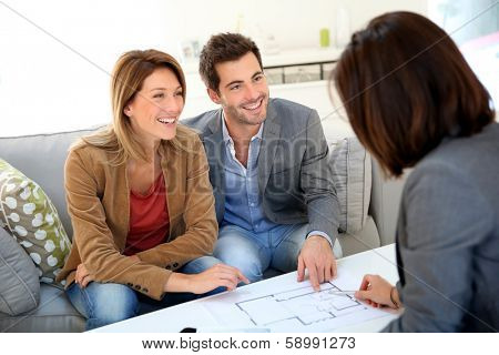 Couple meeting architect for house construction