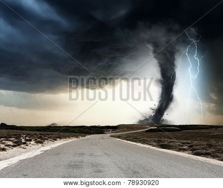 Powerful tornado and lightning above countryside road