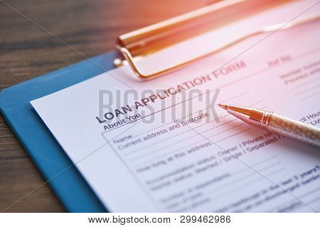 Loan Application Form With Pen On Paper / Financial Loan Negotiation For Lender And Borrower On Busi