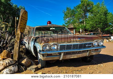 HACKBERRY, ARIZONA, USA - MAY 15: A vintage car with a siren left abandoned near the Hackberry General Store. Hackberry General Store is famous stop on the historic Route 66.