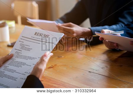 Interviewer Reading A Resume, Person Submits Job Application, Person Describe Yourself To Interviewe