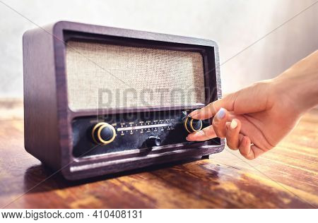 Retro Radio Tuning. Woman Using Old Vintage Music Equipment. Adjusting Volume Or Frequency Tuner Kno