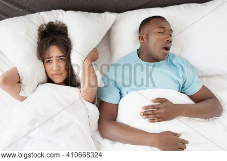 Snoring Man Sleeping With Apnea And Sleepless Woman, Angry Wife Unable To Get To Sleep. Upset Young 