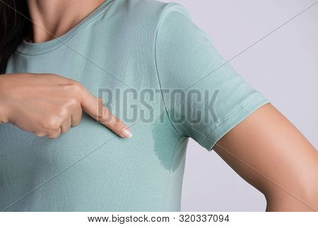 Close-up Asian Woman With Hyperhidrosis Sweating. Young Asia Woman With Sweat Stain On Her Clothes A