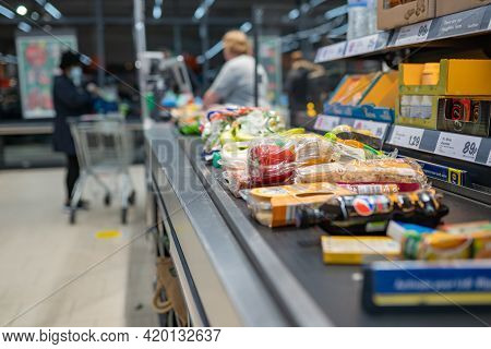 Groceries Shopping At Lidl, Checkout Cashier Counter Belt Full Of Groceries At Supermarket. Shopping