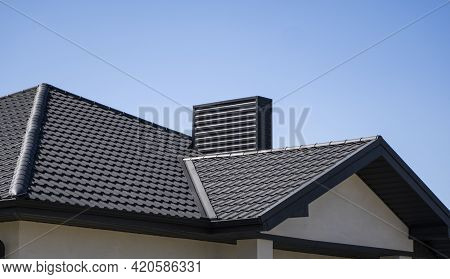 Brown Corrugated Metal Profile Roof Installed On A Modern House. The Roof Of Corrugated Sheet. Roofi