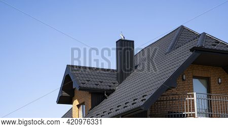 Brown Corrugated Metal Profile Roof Installed On A Modern House. The Roof Of Corrugated Sheet. Roofi