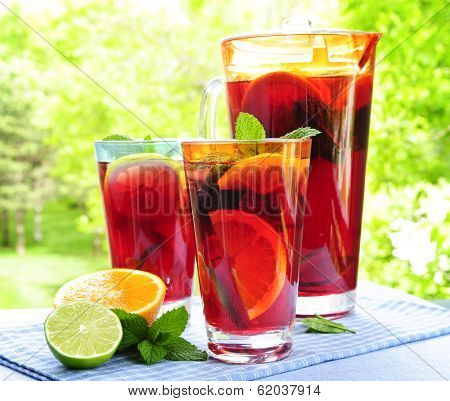 Refreshing fruit punch beverage in pitcher and glasses