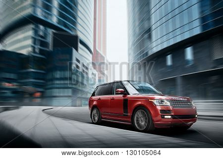 Moscow, Russia - November 22, 2015: Premium car Land Rover Range Rover fast drive on road in the city at daytime