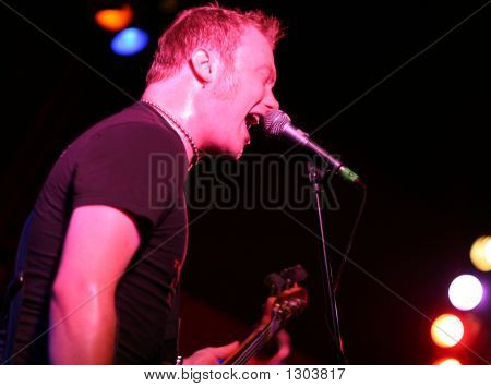 Rockstar Singing And Playing Guitar On Stage