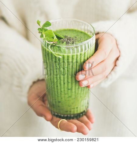 Matcha Green Vegan Smoothie With Chia Seeds And Mint In Glass In Hands Of Female Wearing White Sweat