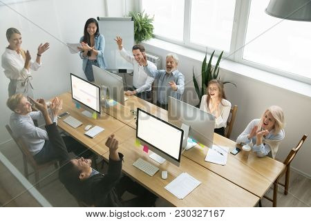 Excited Diverse Team Celebrating Corporate Business Success Applauding African Coworker Congratulati