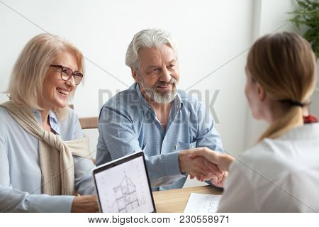 Smiling Satisfied Senior Couple Making Sale Purchase Deal Concluding Contract Handshaking Real Estat