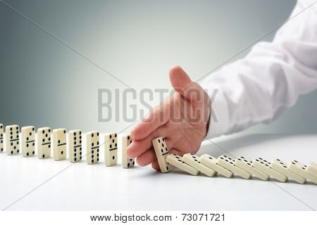 Stopping the domino effect concept for business solution, strategy and successful intervention