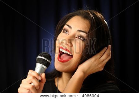 Woman singing in recording studio