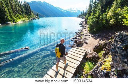 Hiking man in Canadian mountains. Hike is the popular recreation activity in North America. There are a lot of picturesque trails.