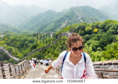 China travel at Great Wall. Tourist in Asia walking on famous Chinese tourist destination and attraction in Badaling north of Beijing. Woman traveler hiking great wall enjoying her summer vacation.