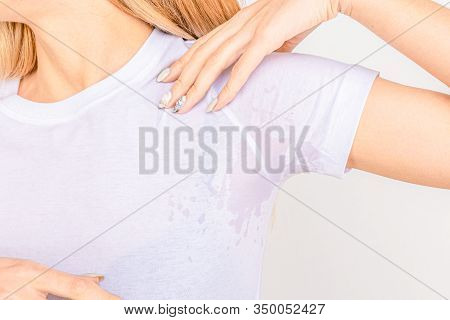 Close-up Asian Woman With Hyperhidrosis Sweating. Young Asia Woman With Sweat Stain On Her Clothes A