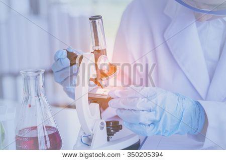 Female Scientist Look At Microscope, Science Test Tube Analyse Scientific Sample In Laboratory Resea