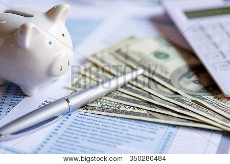 Calculating Tax Refund Or Income Tax Return For Saving Tax, Target For Save Coin In The Piggy Bank. 